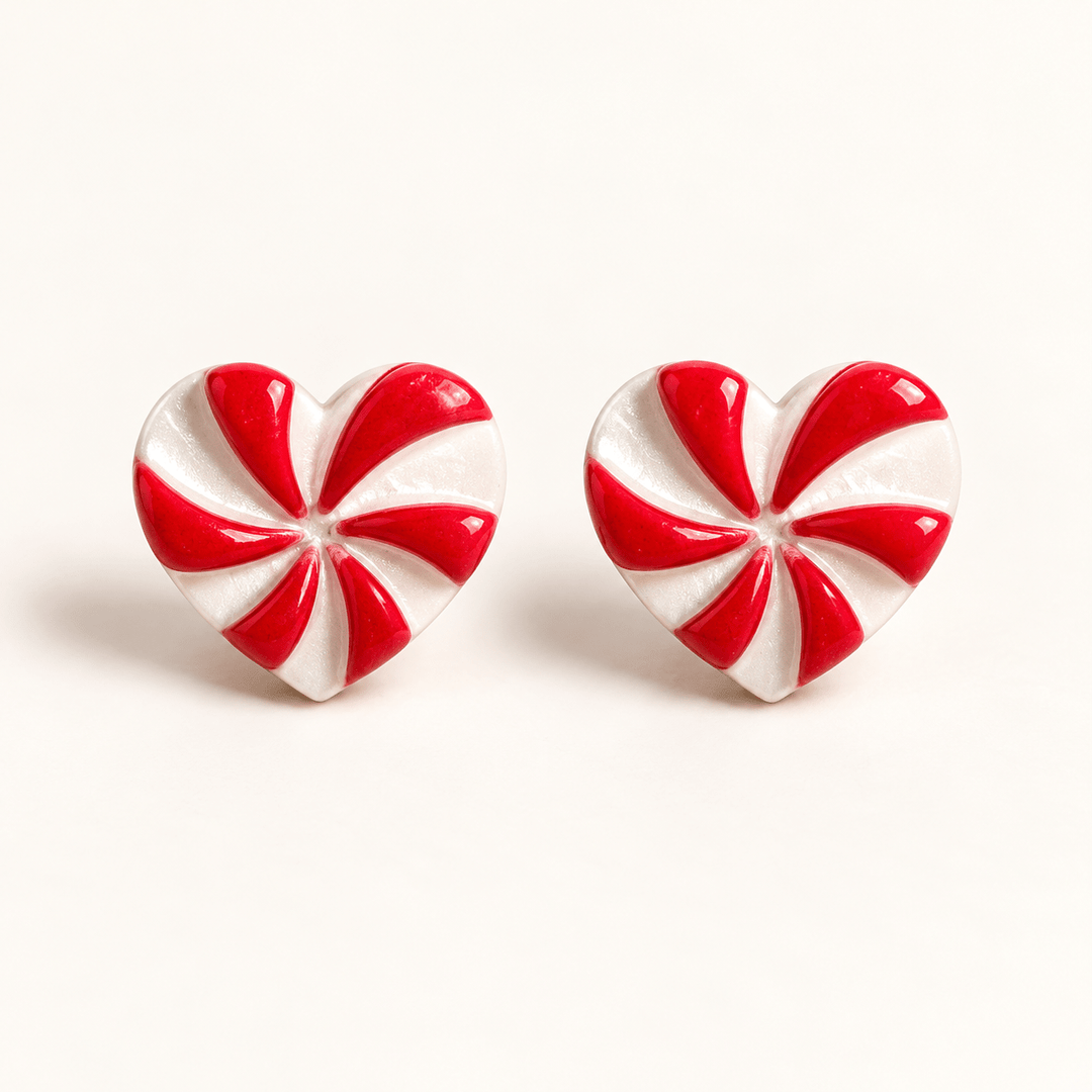 Darcie handmade peppermint heart stud earrings with red and pearly white swirls on white.