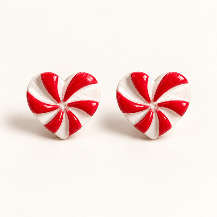 Darcie handmade peppermint heart stud earrings with red and pearly white swirls on white.