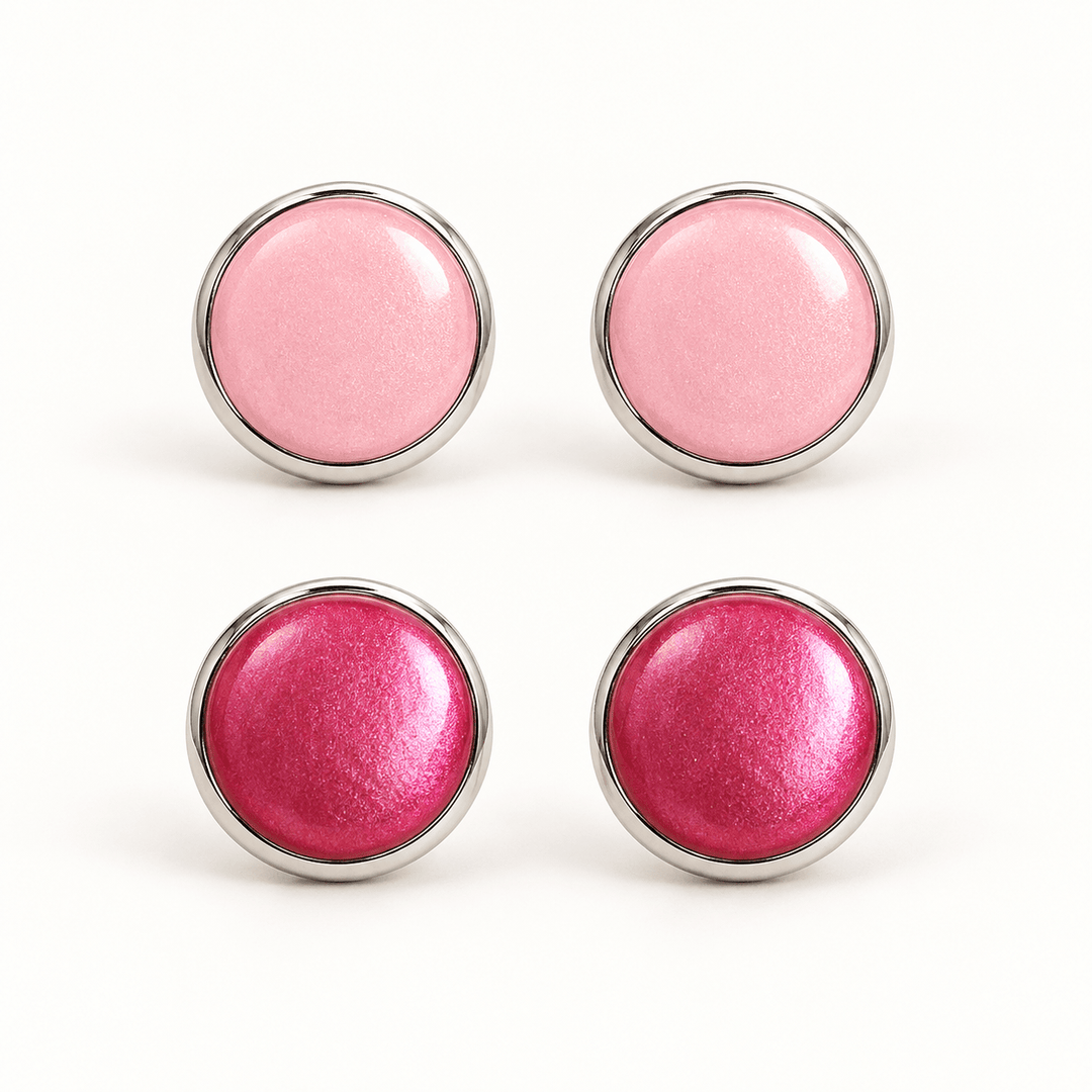 Nerine pastel pink and fuchsia pearlescent clay stud earrings in silver-tone bezels on white.