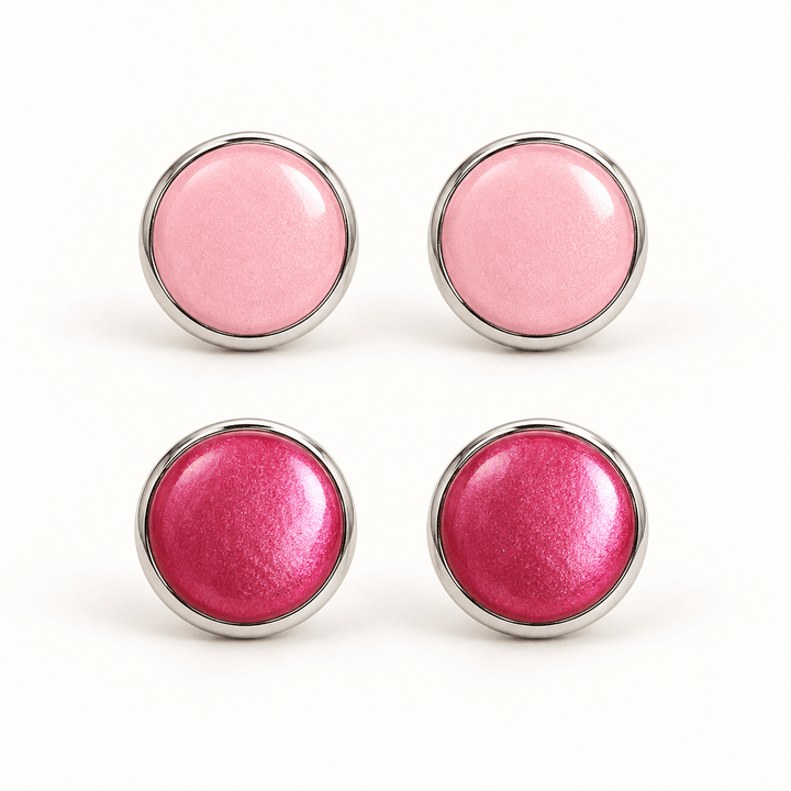 Nerine pastel pink and fuchsia pearlescent clay stud earrings in silver-tone bezels on white.