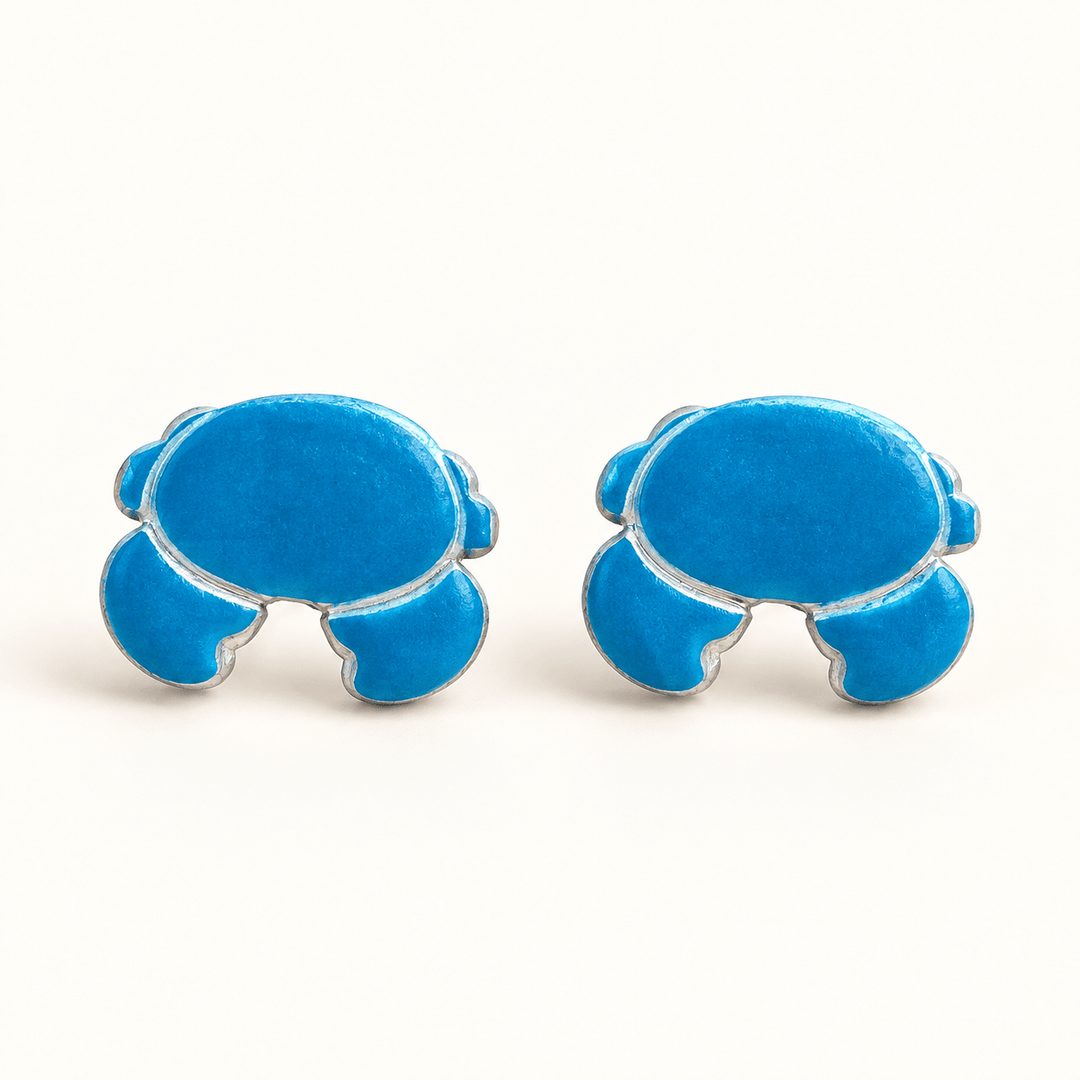 Nerissa handmade blue crab stud earrings on white.