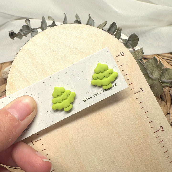 Noella stud earrings beside a ruler showing size and scale
