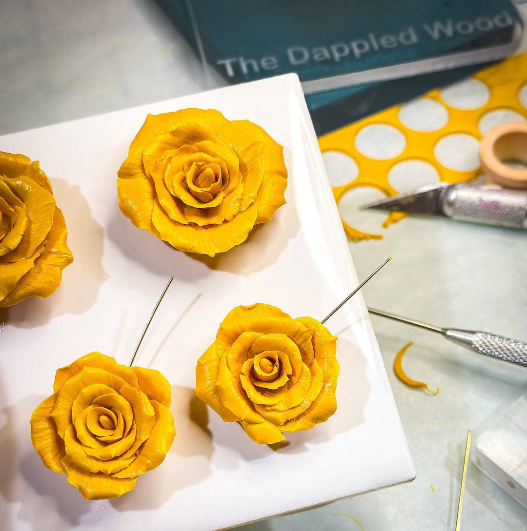 Rosella - Sculpted Rose Earrings displayed in a product photo.