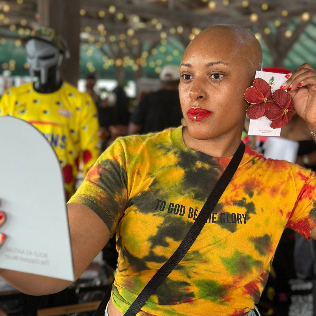 Customer showcasing the Sabine earrings in Garnet from The Dappled Wood featuring deep red floral petals with gold accents.
