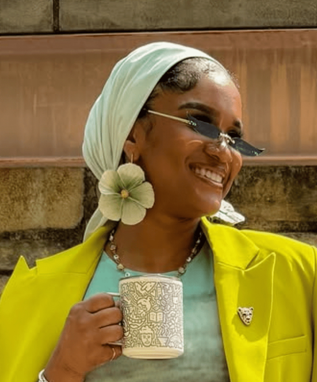 Customer wearing the Sabine earrings in Sage by The Dappled Wood, highlighting soft green petal inspired statement drops styled with a bright outfit in natural outdoor light.