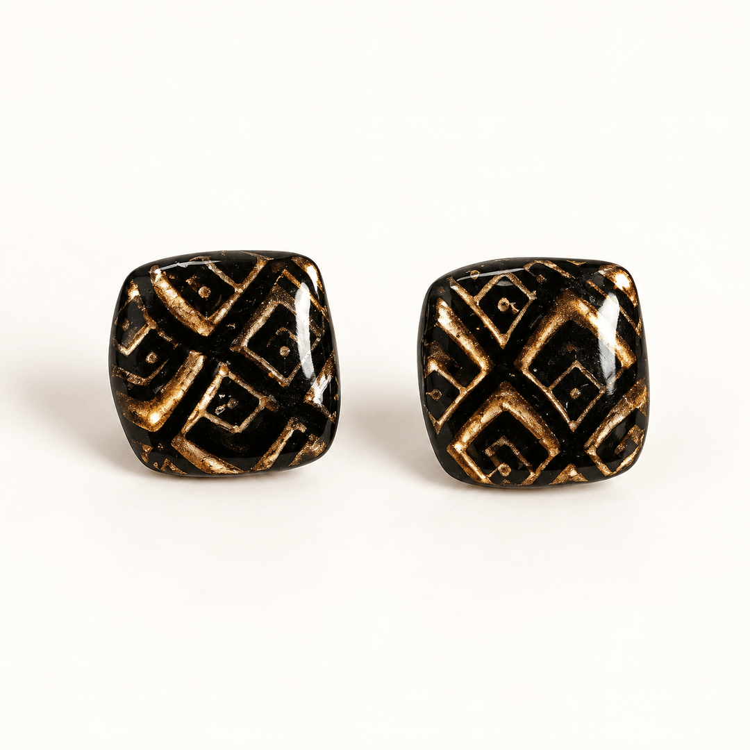 Safiya black and gold diamond pattern soft-square stud earrings on white.