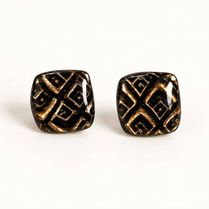 Safiya black and gold diamond pattern soft-square stud earrings on white.