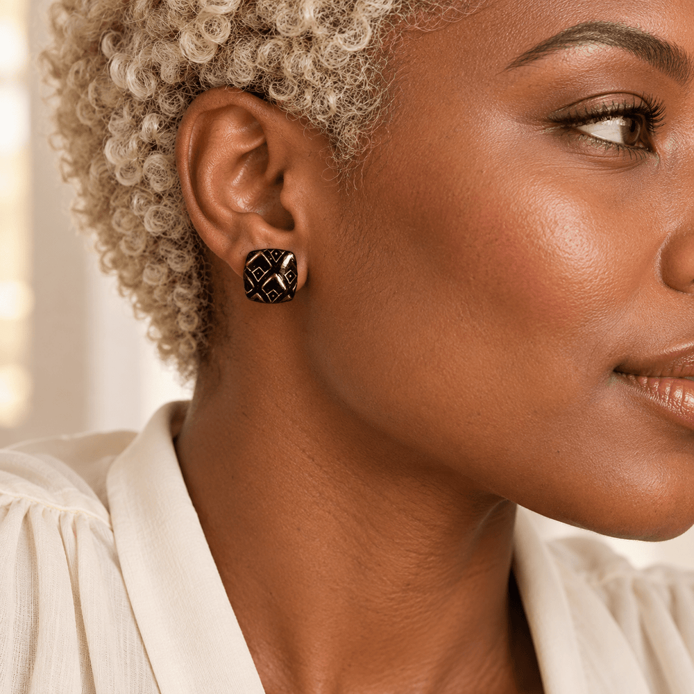 AI-generated styling preview of Safiya black and gold diamond studs on a model with platinum coils; scale illustrative.