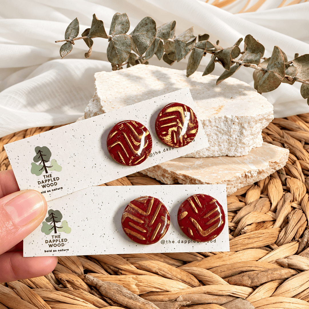 Safiya red and gold bold linear pattern round stud earrings.