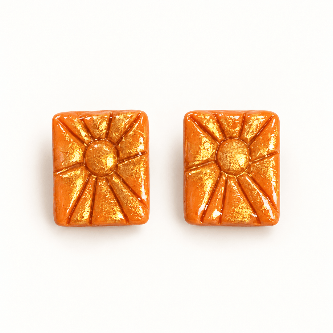 Soleil orange rectangular sunburst stud earrings with gold accents and a glossy finish