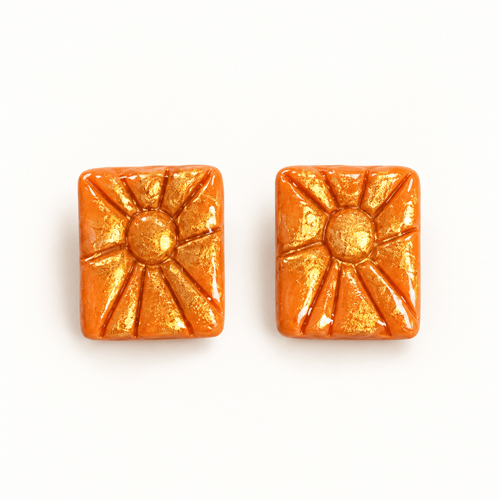 Soleil orange rectangular sunburst stud earrings with gold accents and a glossy finish