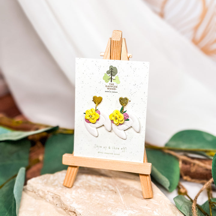 The Dappled Wood Blooming Bunny Earrings for Spring 2024 featuring handmade polymer clay with a floral design, perfect for sensitive ears.