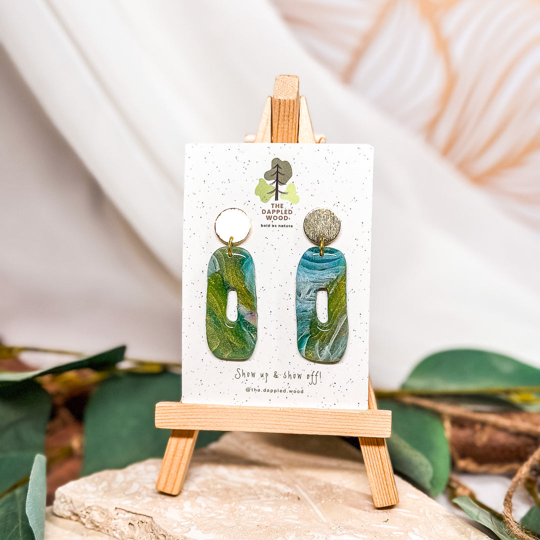 The Dappled Wood Oakley one-of-a-kind handmade earrings from the Spring 2024 collection featuring a green faux stone polymer clay design, suitable for sensitive ears.