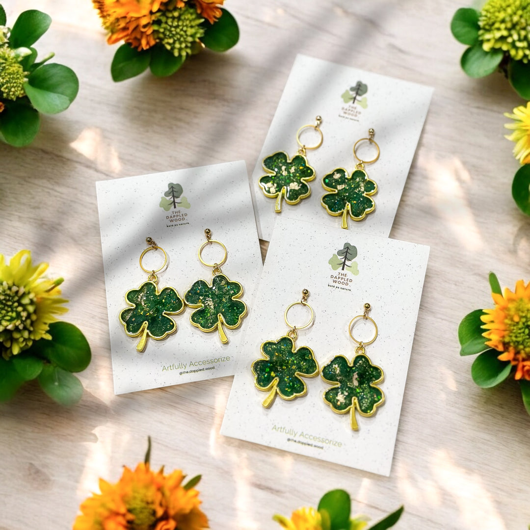 A set of three of The Dappled Wood's Brigid Golden Shamrock earrings. Handmade and Hypoallergenic St Patrick's Day Accessories.