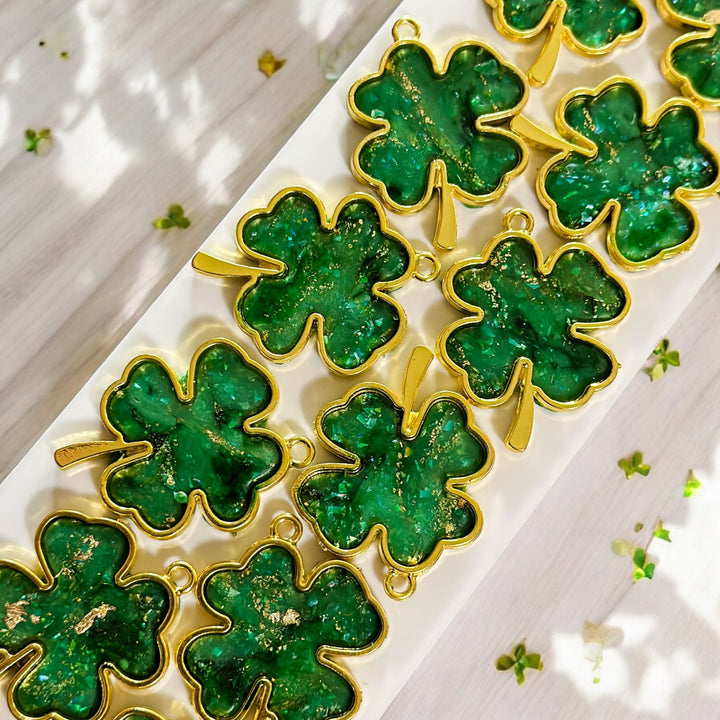 A row of work in progress The Dappled Wood's Brigid Golden Shamrock earrings. Handmade and Hypoallergenic St Patrick's Day Accessories.