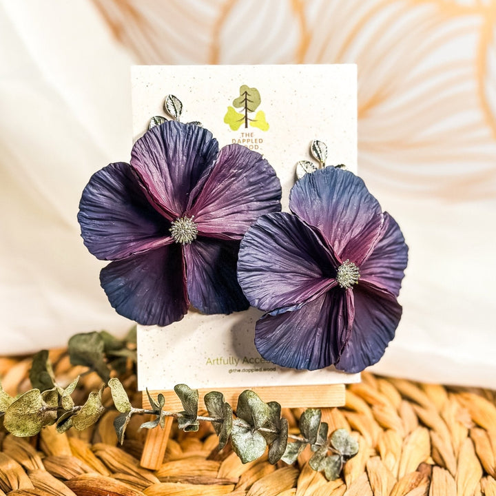 The Dappled Wood's Sabine polymer clay flower earrings in Eclipse feature a plum to navy blue gradient. Bold floral clay earrings and lightweight statement jewelry, perfect for formal events or night outs.
