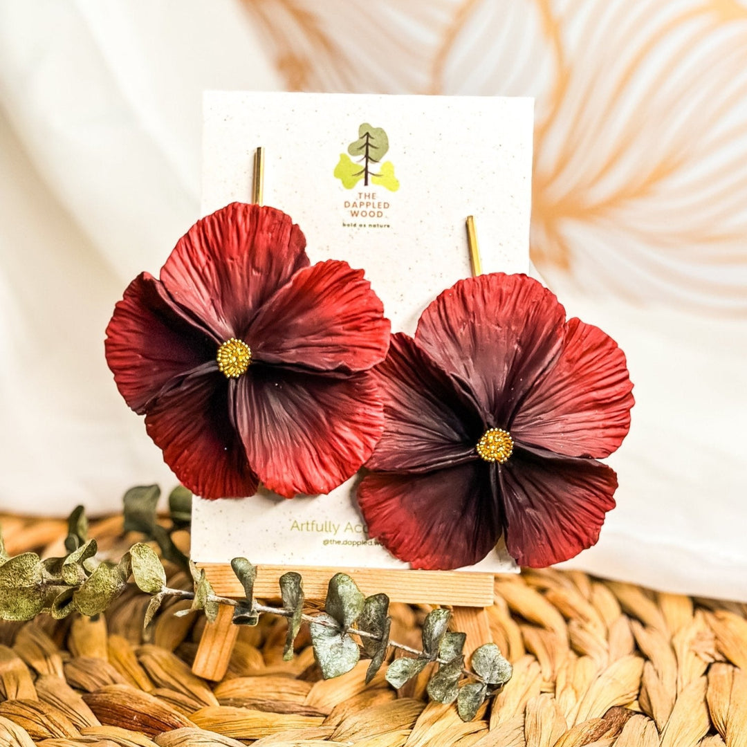 The Dappled Wood's Sabine polymer clay flower earrings in Garnet feature a deep red gradient. Bold floral clay earrings and lightweight statement jewelry, perfect for evening events or romantic date nights.