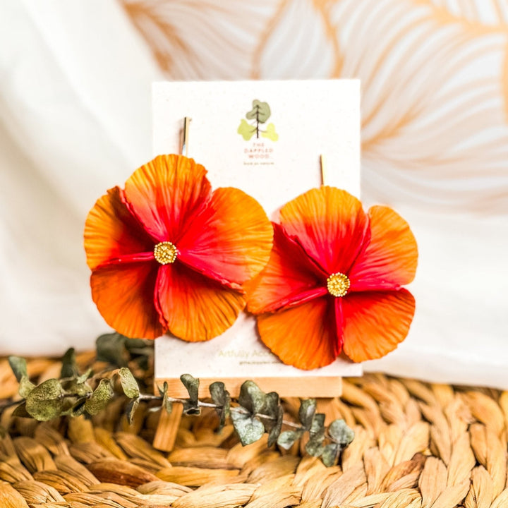 The Dappled Wood's Sabine polymer clay flower earrings in Papaya feature a dark pink to orange gradient. Bold floral clay earrings and lightweight statement jewelry, perfect for summer festivals or beach vacations.