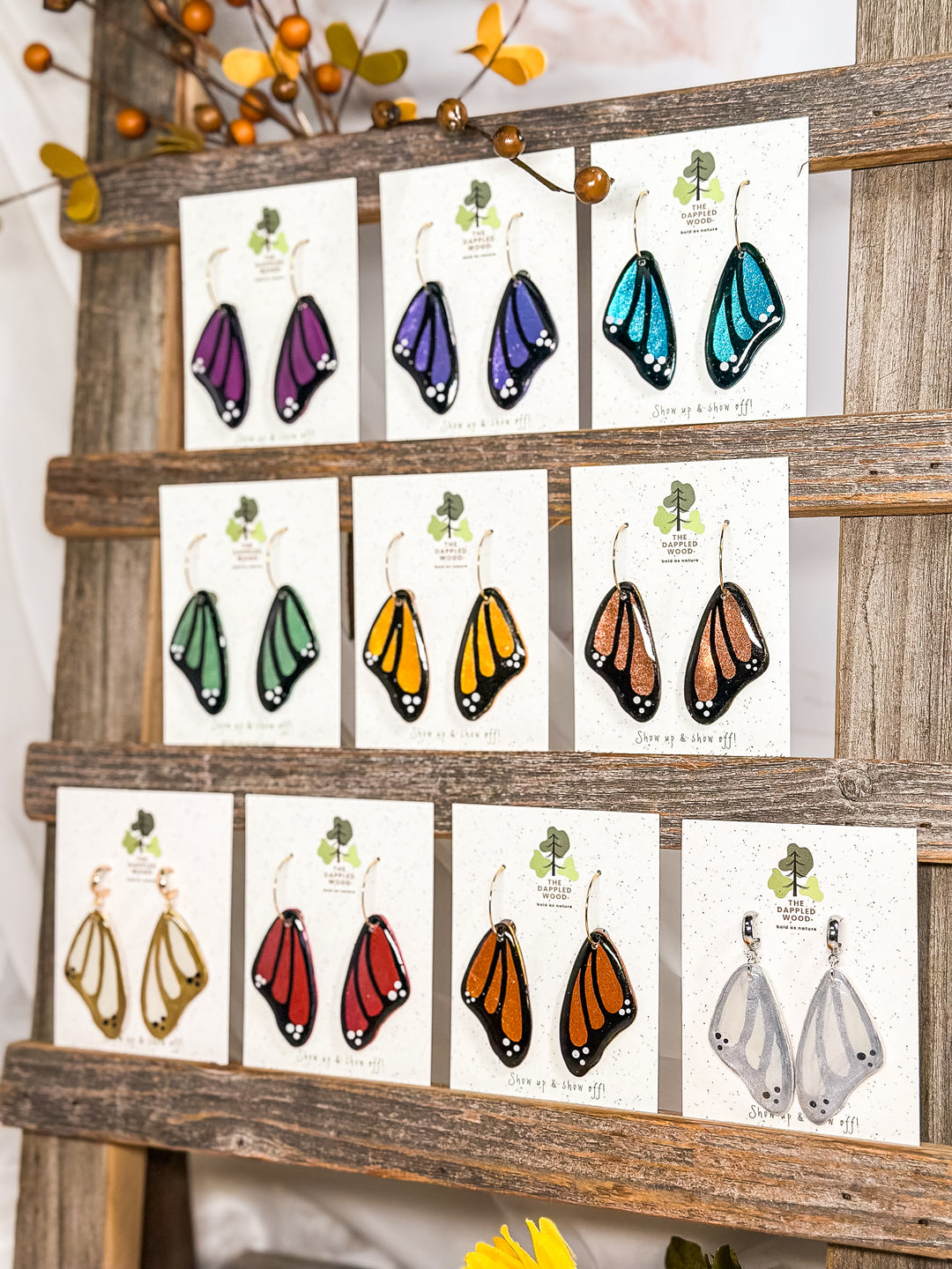 The Winged Whispers Collection by The Dappled Wood, a best-selling lineup of lightweight and hypoallergenic butterfly wing earrings in a rainbow of colors.