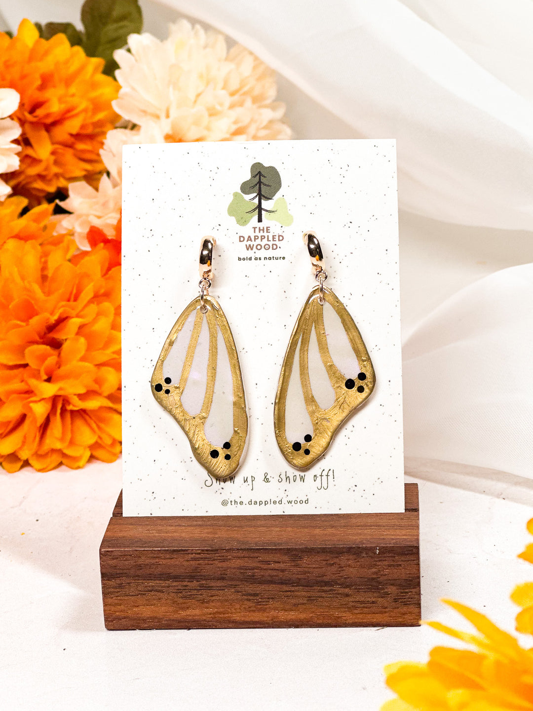 Gold butterfly wing earrings from The Dappled Wood, shimmering hypoallergenic jewelry inspired by nature’s elegance.