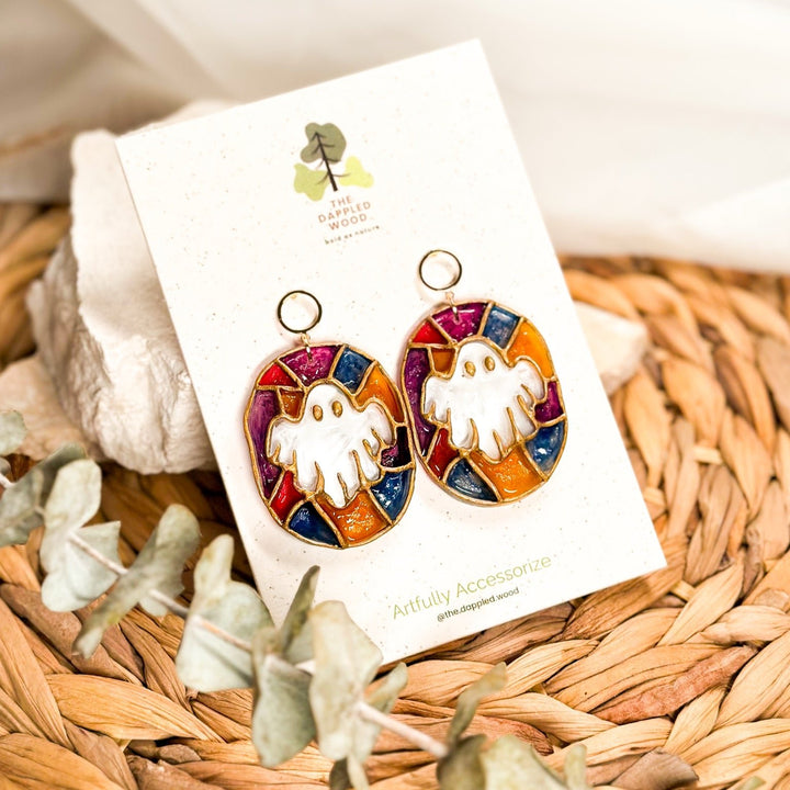 Winifred stained glass ghost earrings with white ghosts, jewel-toned panels, and gold details.