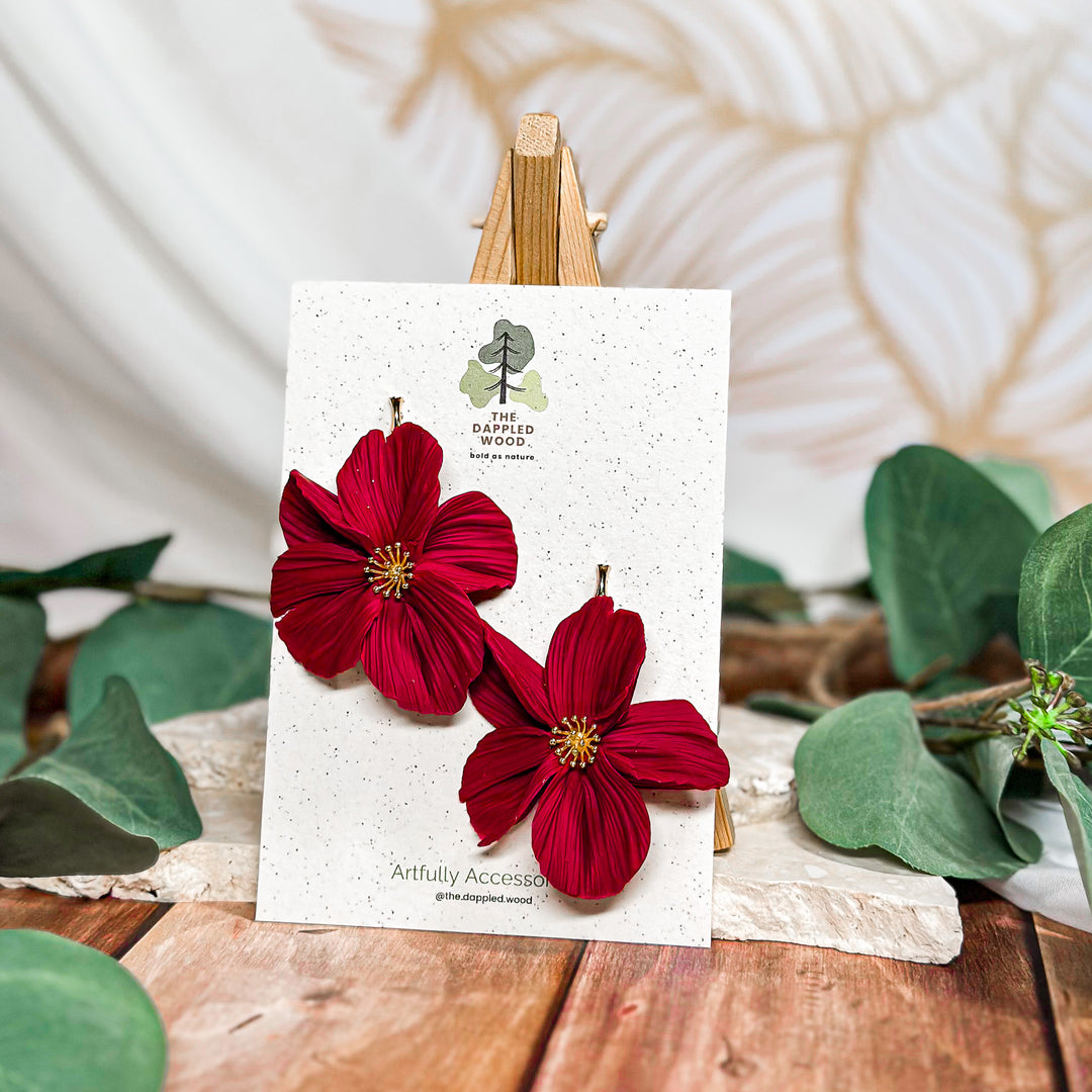 The Dappled Wood Frosted Petals handsculpted winter floral earrings in cherry featuring a hypoallergenic gold bamboo post from the New Year 2025 collection.