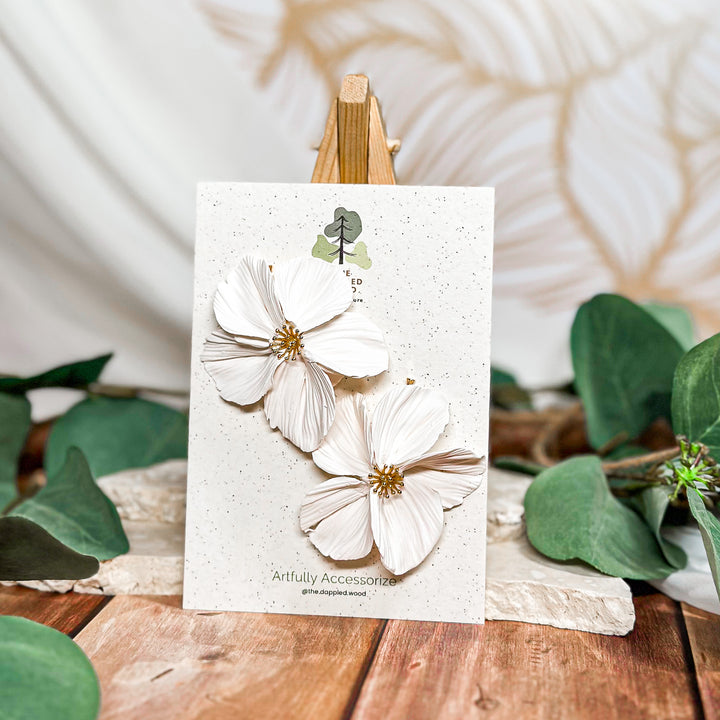 The Dappled Wood Frosted Petals handsculpted winter floral earrings in snowdrift white featuring nickel free gold bamboo posts from the New Year 2025 collection.